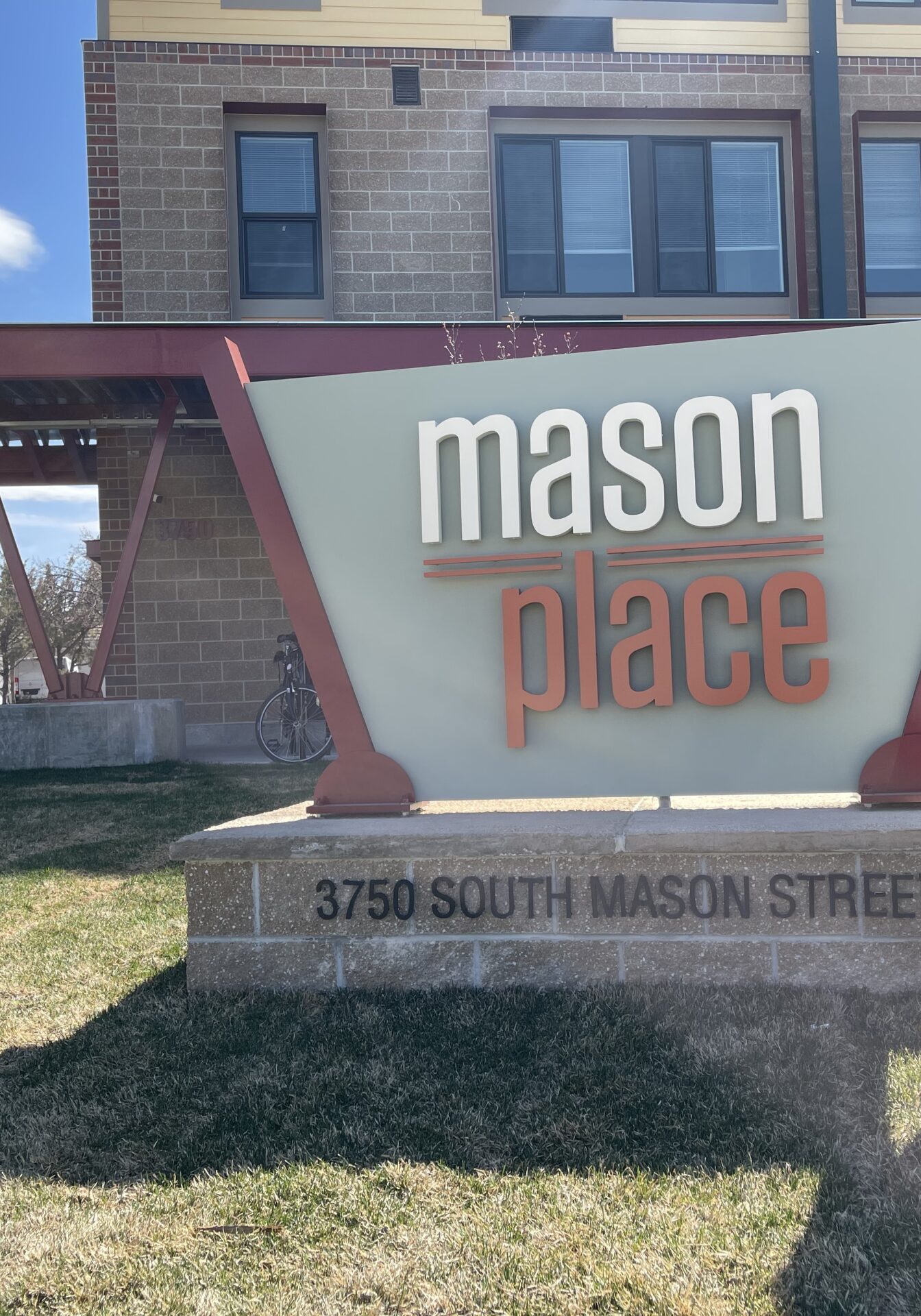 Man standing next to Mason Place